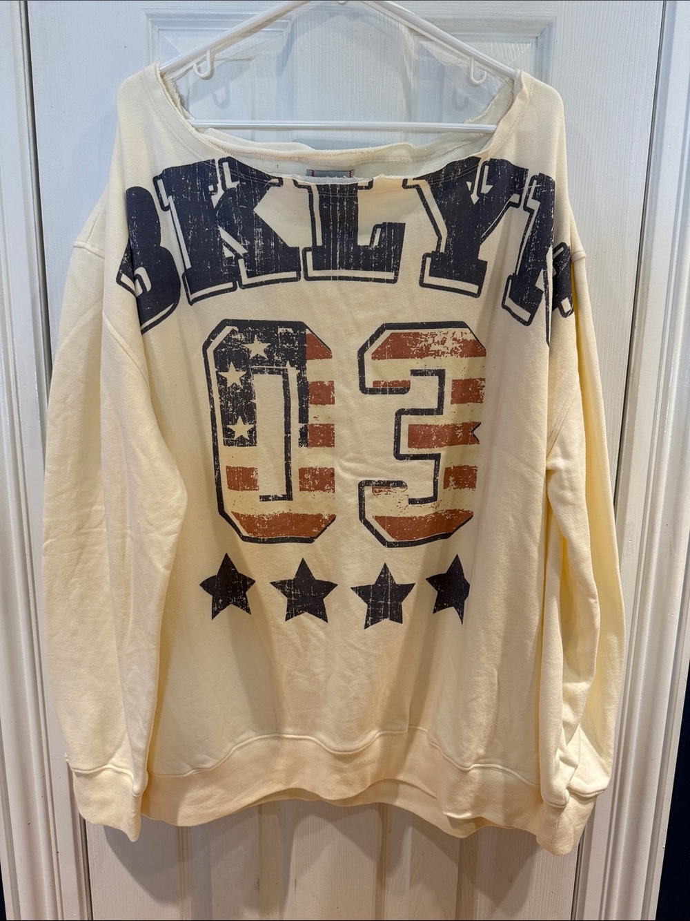 BDG Off-the-Shoulder Cream Sweatshirt with Distressed Navy & Rust Graphic